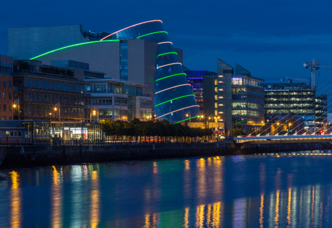 Nightime shot with electric illumination, along the River Liffey and the building on the waterfront near the Convention Centre - Dublin city center in the republic of Ireland.