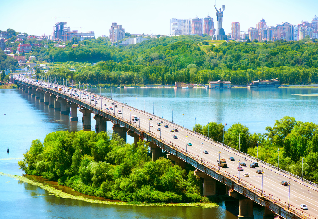 Kiev City in background with river and bridge with road traffic in the foreground