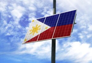 A solar panel with a graphic of the Philippines flag, against a partially cloudy sky