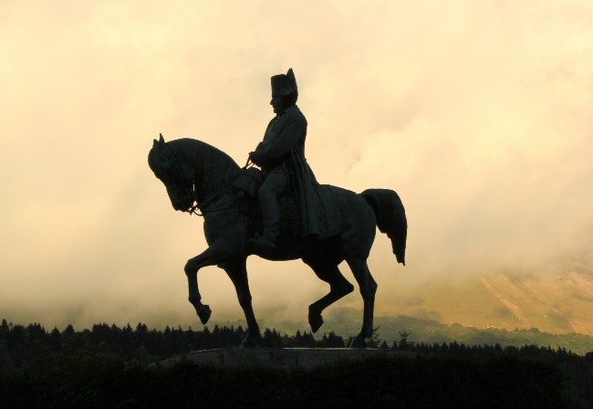 silhouette of Napoleon on horseback statue at sunset