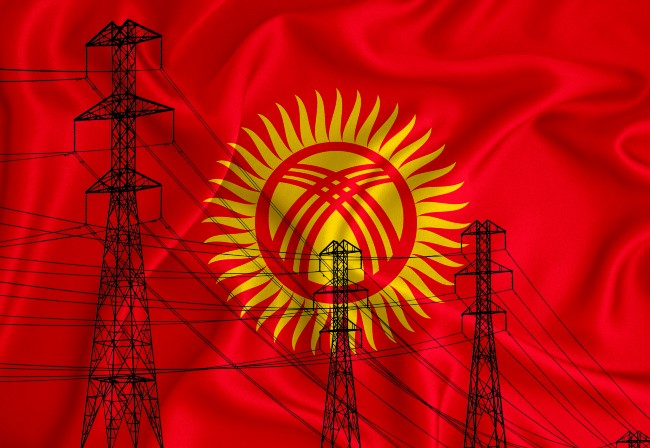 Kyrgyzstan flag, yellow sun symbol on red background shown with silhouettes of electricity pylons